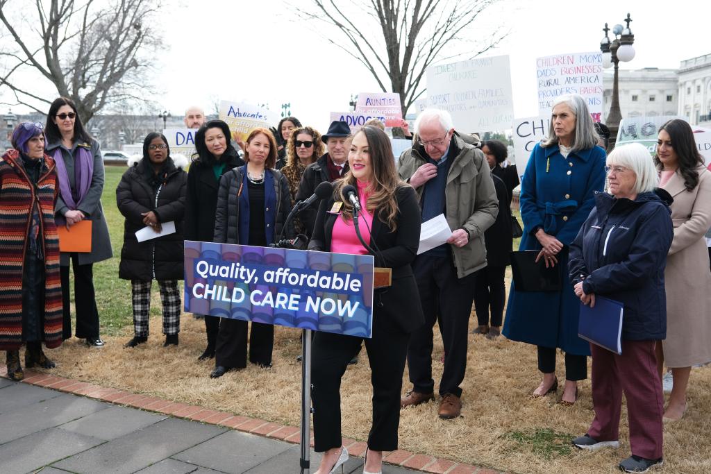 MomsRising member Angelica Gonzolez speaking at a podium during Patty Murray child care press event