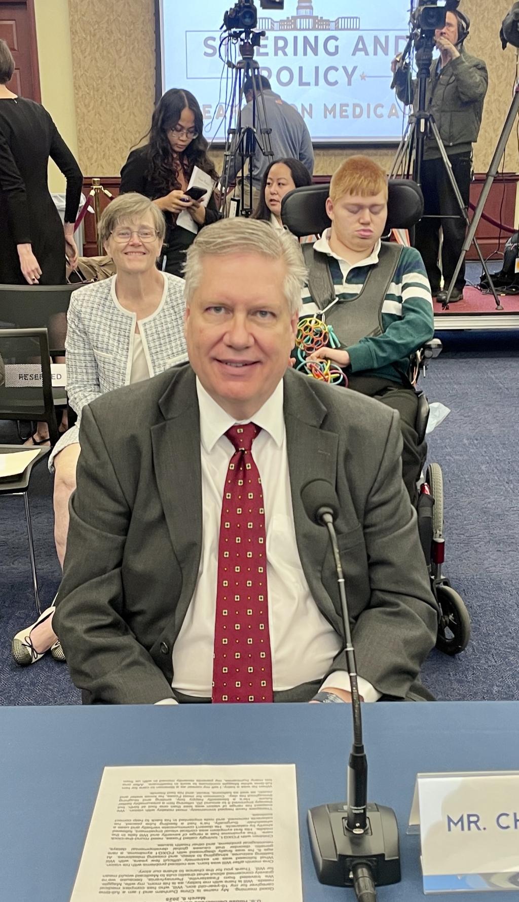 The Dunham family sit together in the Hearing room