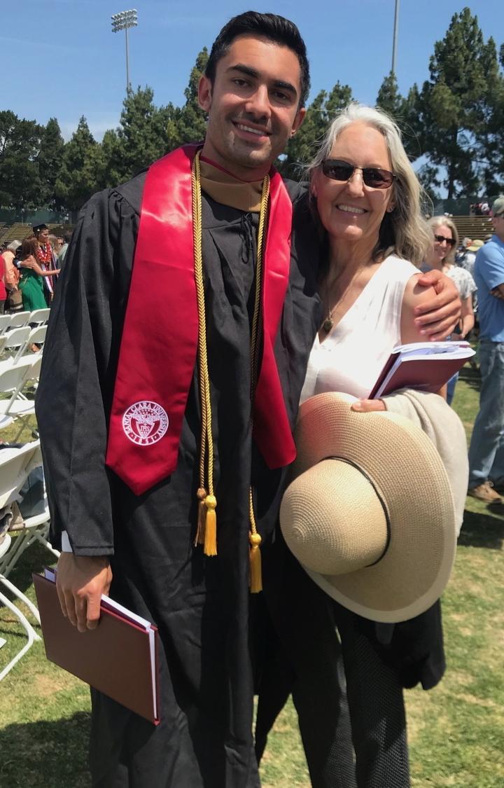 [IMAGE DESCRIPTION: A photo of a proud mom and son looking at the camera and smiling after college graduation.]